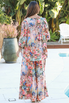 Woman wearing Hannah Blouse in soft rayon with three quarter elastic sleeves and gathered back yoke boho style