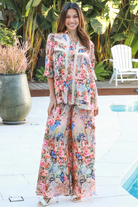 Woman wearing Hannah Blouse in soft rayon with three quarter elastic sleeves and gathered back yoke boho style