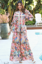 Woman wearing Hanna Pant Rayon with butterfly floral print wide leg silhouette – boho pants Australia
