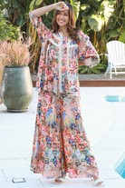 Woman wearing Hanna Pant Rayon with butterfly floral print wide leg silhouette – boho pants Australia