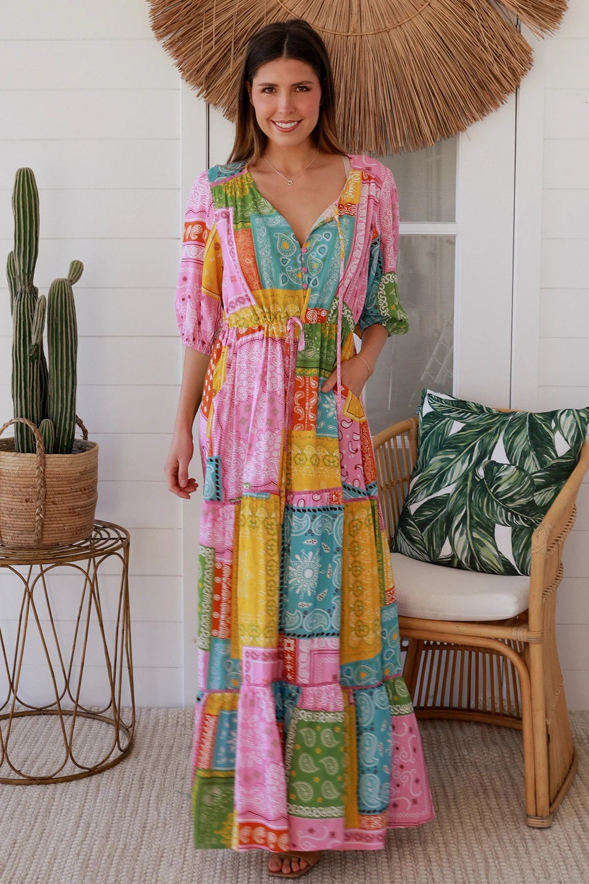Woman in colourful patchwork paisley boho maxi dress with v-neck button bodice and tiered skirt - Boho Fashion Australia
