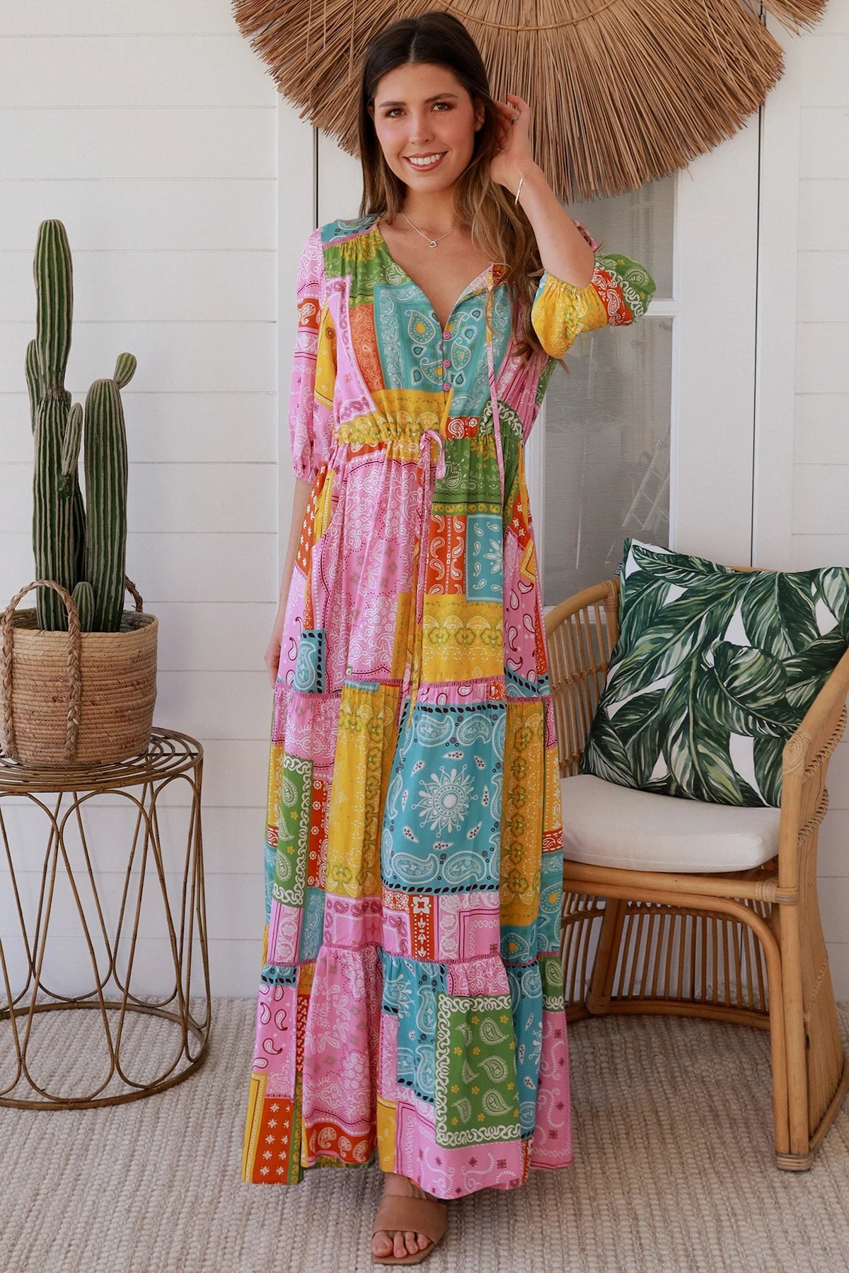 Woman in colourful patchwork paisley boho maxi dress with v-neck button bodice and tiered skirt - Boho Fashion Australia