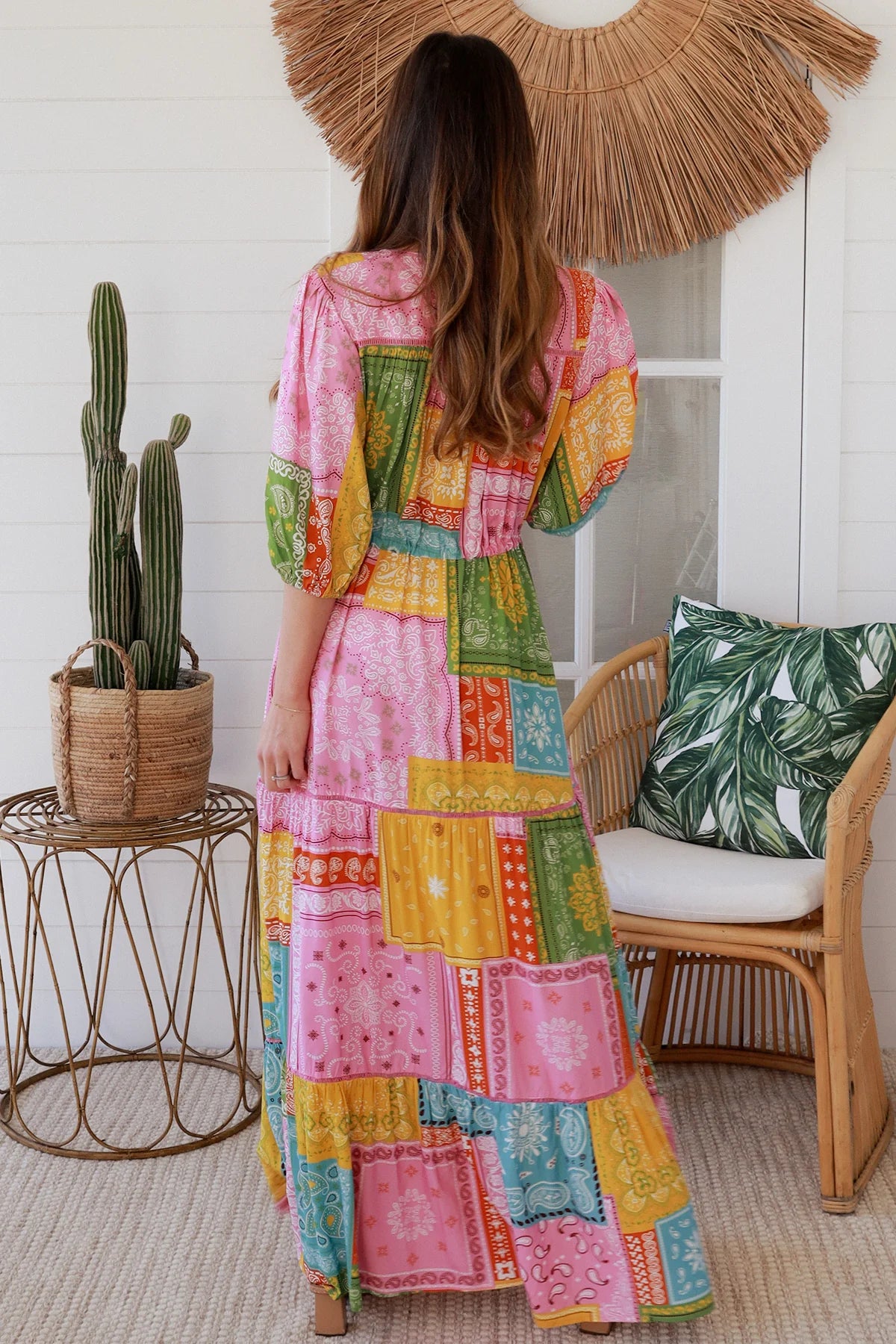 Woman in colourful patchwork paisley boho maxi dress with v-neck button bodice and tiered skirt - Boho Fashion Australia