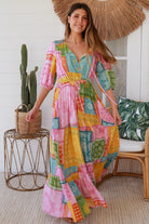 Woman in colourful patchwork paisley boho maxi dress with v-neck button bodice and tiered skirt - Boho Fashion Australia