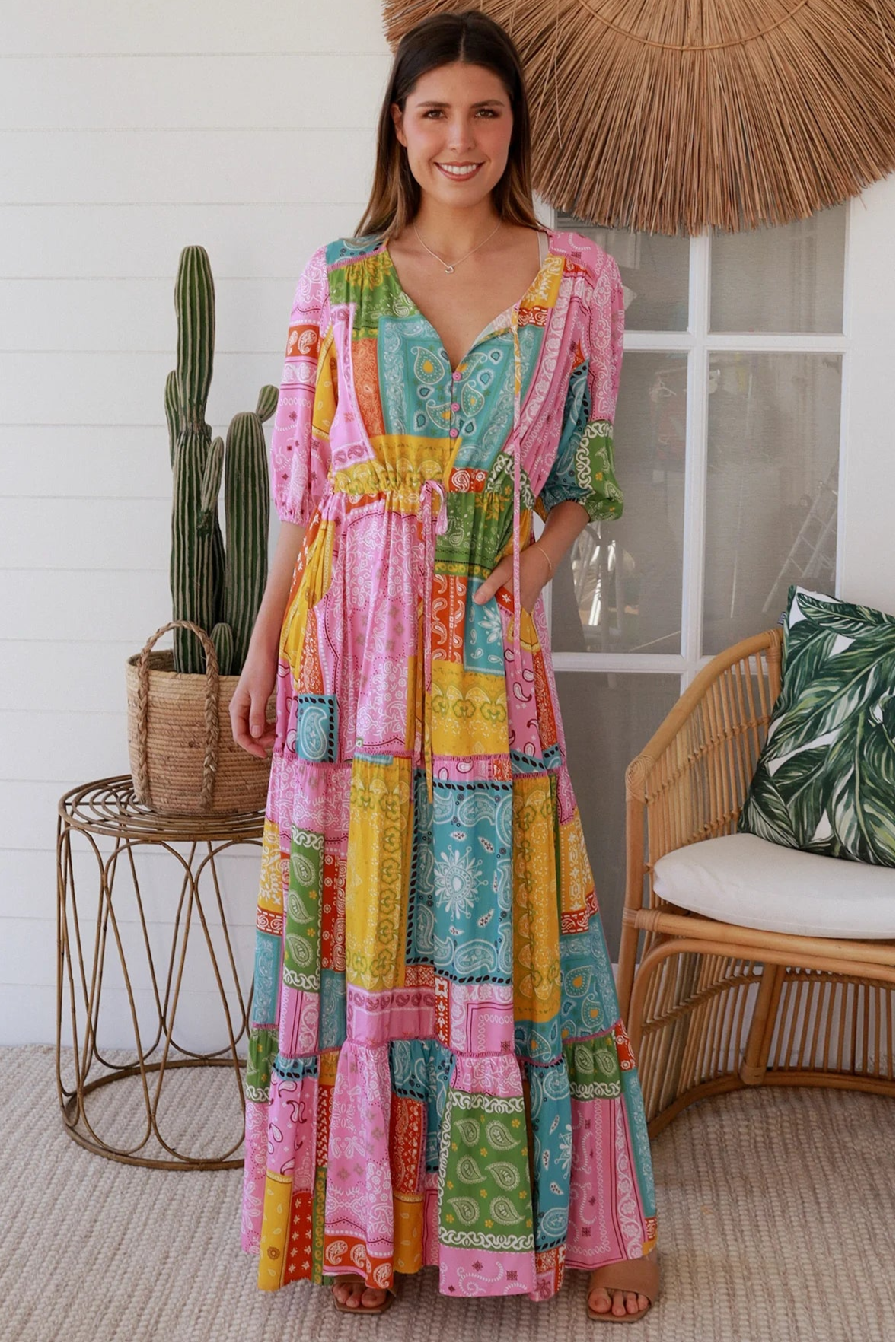 Woman in colourful patchwork paisley boho maxi dress with v-neck button bodice and tiered skirt - Boho Fashion Australia