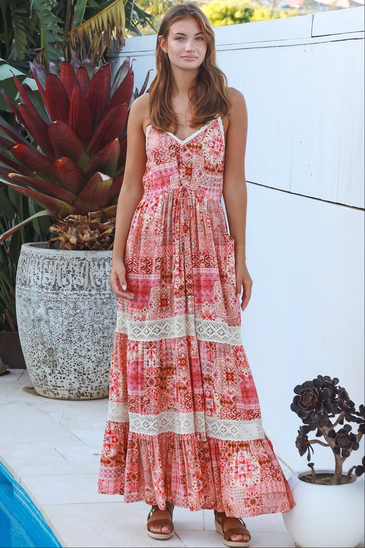 Woman wearing blush coral tiered rayon maxi dress with ivory lace, Dreamcatcher print, flowing summer boho style