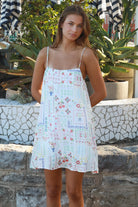 Izadora mini dress by Salty Palm with patchwork print, adjustable straps and A-line shape styled for summer.