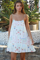 Izadora mini dress by Salty Palm with patchwork print, adjustable straps and A-line shape styled for summer.