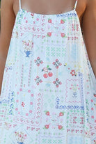 Izadora mini dress by Salty Palm with patchwork print, adjustable straps and A-line shape styled for summer.