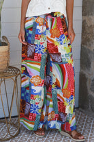 Bright 70s patchwork rayon wide-leg pants in bold multicoloured print — Ingrid Pant summer boho style.