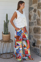 Bright 70s patchwork rayon wide-leg pants in bold multicoloured print — Ingrid Pant summer boho style.