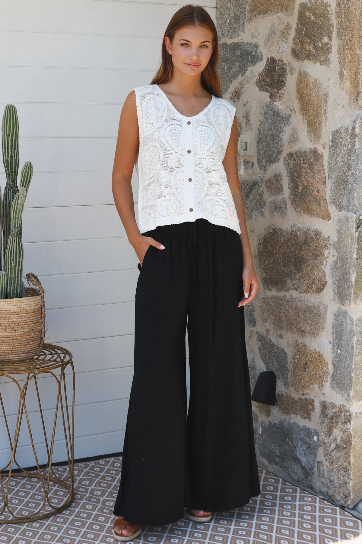 Black wide-leg rayon pants with elastic waist, front tie and side pockets