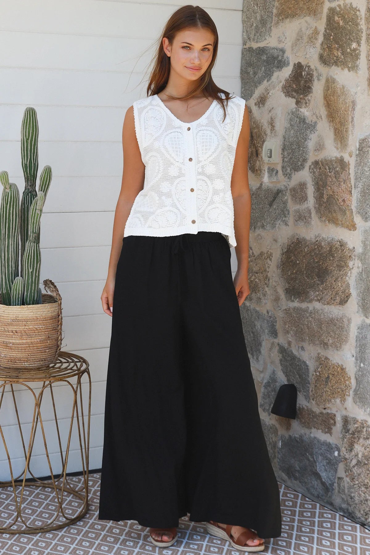 Black wide-leg rayon pants with elastic waist, front tie and side pockets