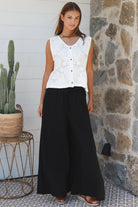 Black wide-leg rayon pants with elastic waist, front tie and side pockets