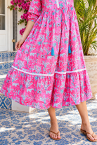 Mahale Sanctuary Midi Dress Pluto Pink in 100% cotton with turquoise wildlife print, white lace trim and frill hem