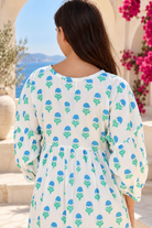 Lovebird blue cotton boho mini dress with green floral block print, tassel V-neckline and gathered empire waist