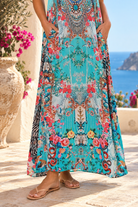 Mirage aqua blue rhinestone maxi dress in viscose crepe with vivid floral placement print and flowing skirt
