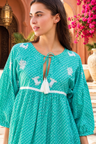 Maya jade cotton boho mini dress with white crab and coral embroidery, tassel neckline and three-quarter sleeves