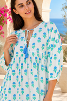 Lovebird blue cotton boho mini dress with green floral block print, tassel V-neckline and gathered empire waist