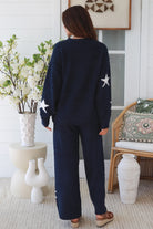 Charlotte The Label Star Soft Brushed Knit Pants in navy featuring a soft brushed knit, closely placed white star design, wide-leg silhouette and elastic waistband.