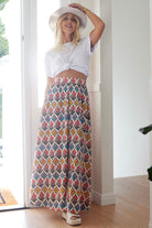 Boho cotton maxi skirt with red floral and geometric print, elastic waistband, and white background.