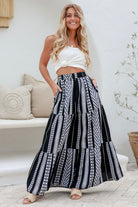 women wearing the Lunar Cotton Boho Maxi Skirt - full-length black and white boho skirt with geometric print, tiered silhouette, and cotton fabric.