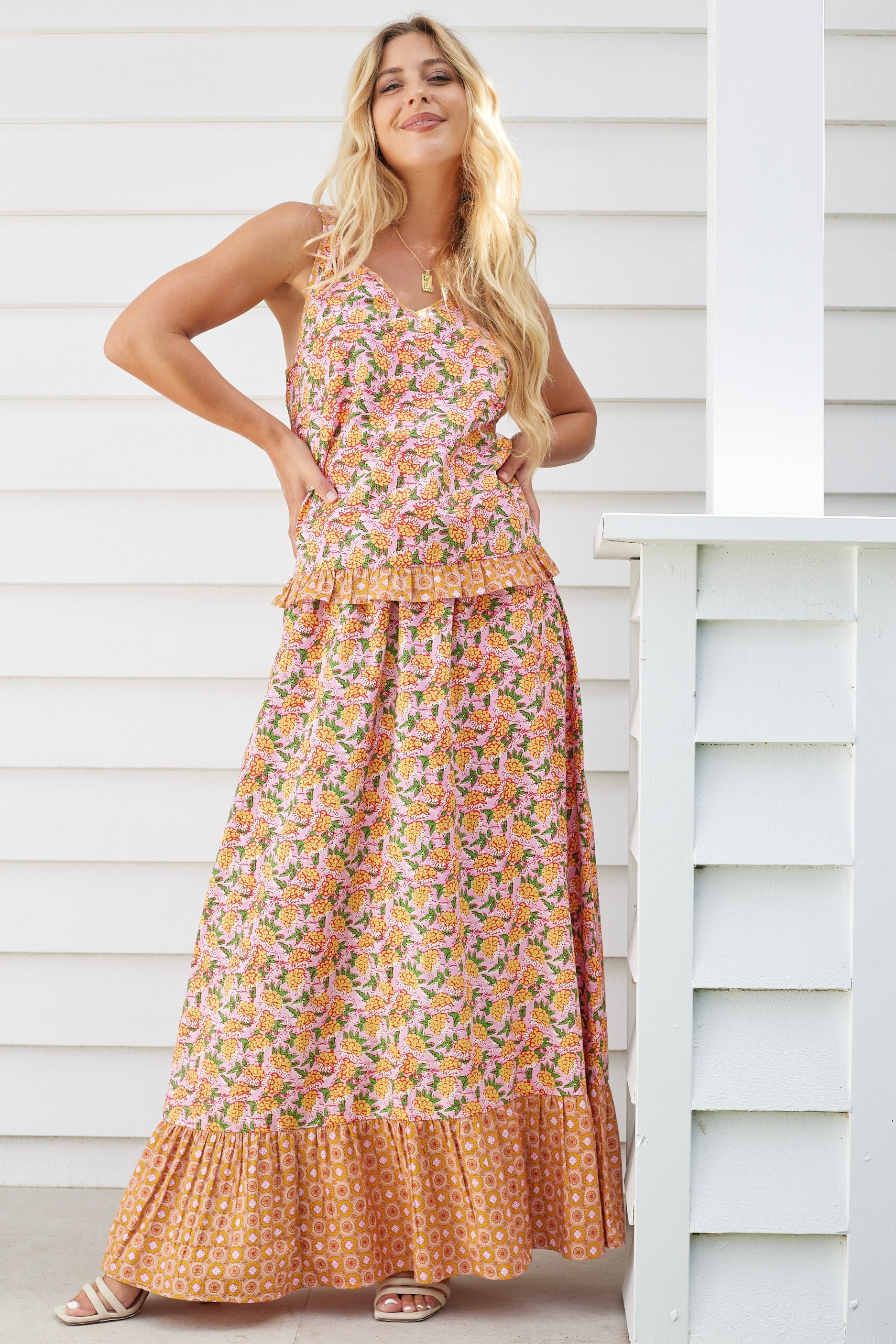 Model wearing boho floral cami top and maxi skirt set in orange and pink