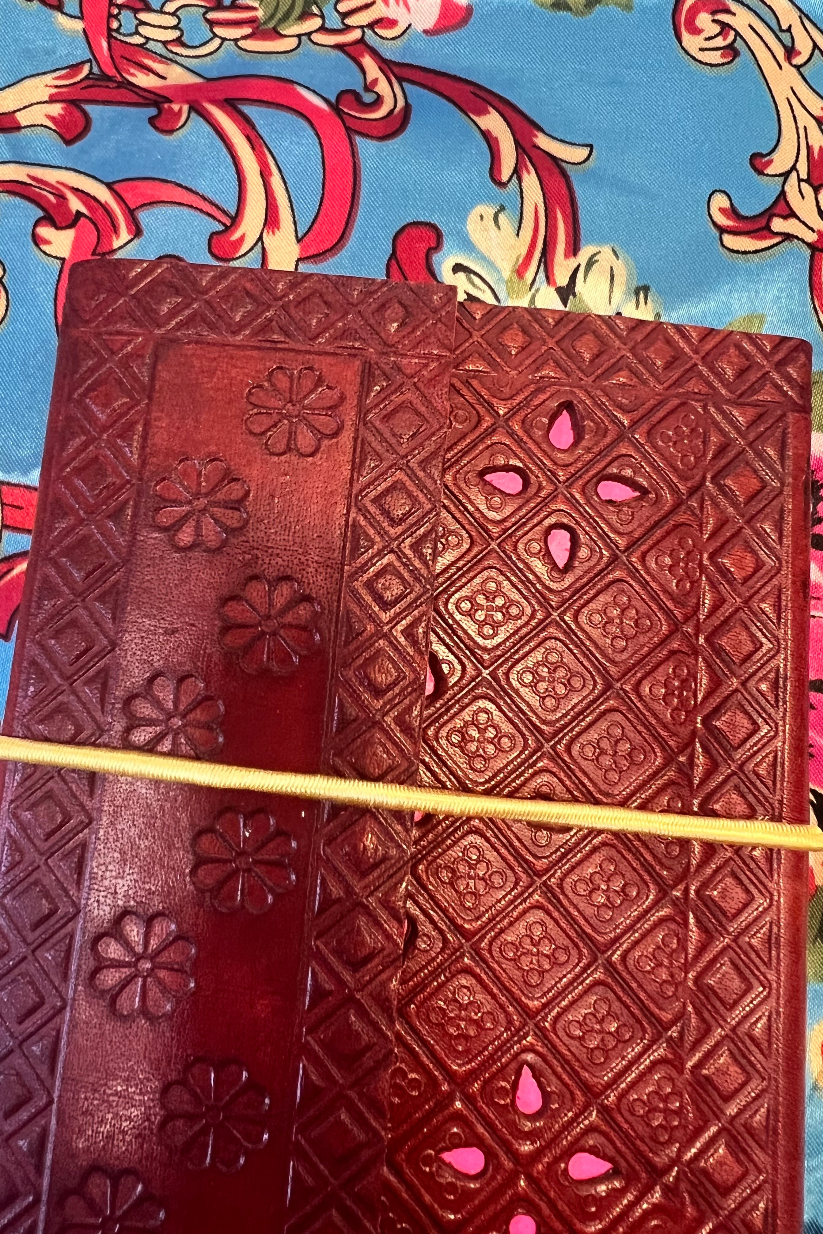 Golden-brown hand-tooled leather B5 journal with embossed curved pattern and blank recycled pages - boho artisan notebook