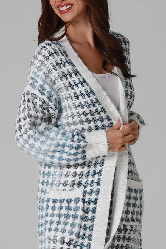 Woman wearing Juliet white and blue houndstooth longline fringe knit cardigan with drop shoulder sleeves, ribbed cuffs and front pockets by Charlotte The Label.