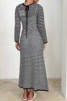 Woman wearing black and white striped knit maxi dress with long sleeves and round neckline -  boho cotton knit dress Australia.