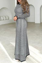 Woman wearing black and white striped knit maxi dress with long sleeves and round neckline -  boho cotton knit dress Australia.