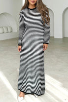 Woman wearing black and white striped knit maxi dress with long sleeves and round neckline -  boho cotton knit dress Australia.