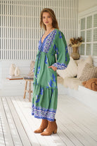 Model wearing Bluebird Willa Boho Midi Dress by Jaase - floral print, long sleeves, 100% rayon, drawstring waist.