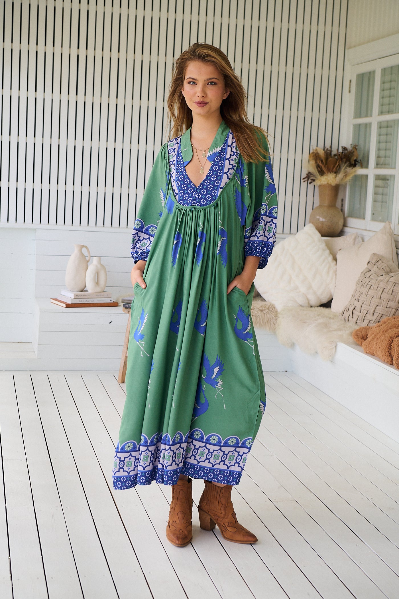 Model wearing Bluebird Boheme Midi Dress by Jaase - boho floral print, long sleeves, soft rayon fabric, relaxed flowy silhouette.