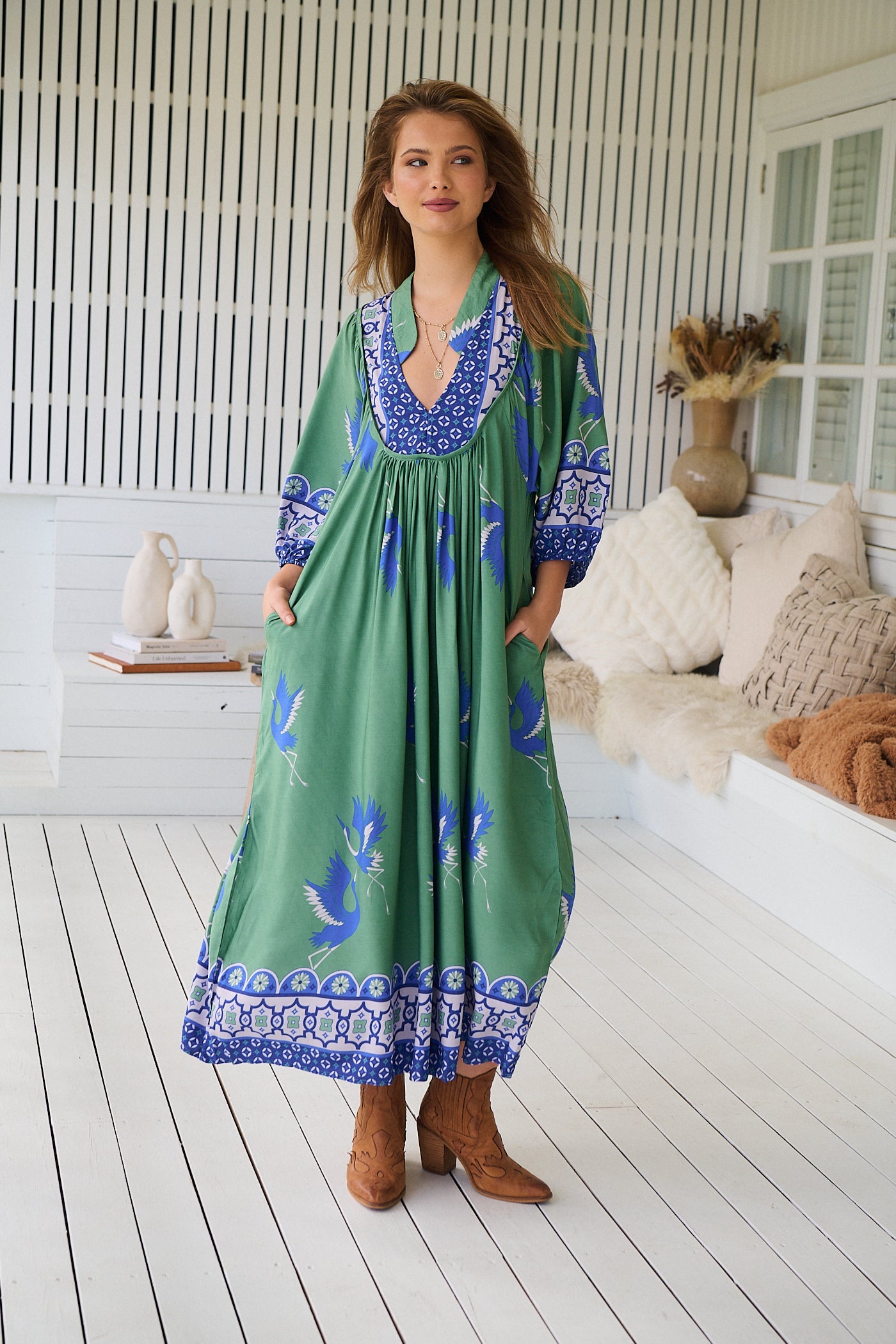 Model wearing Bluebird Boheme Midi Dress by Jaase - boho floral print, long sleeves, soft rayon fabric, relaxed flowy silhouette.