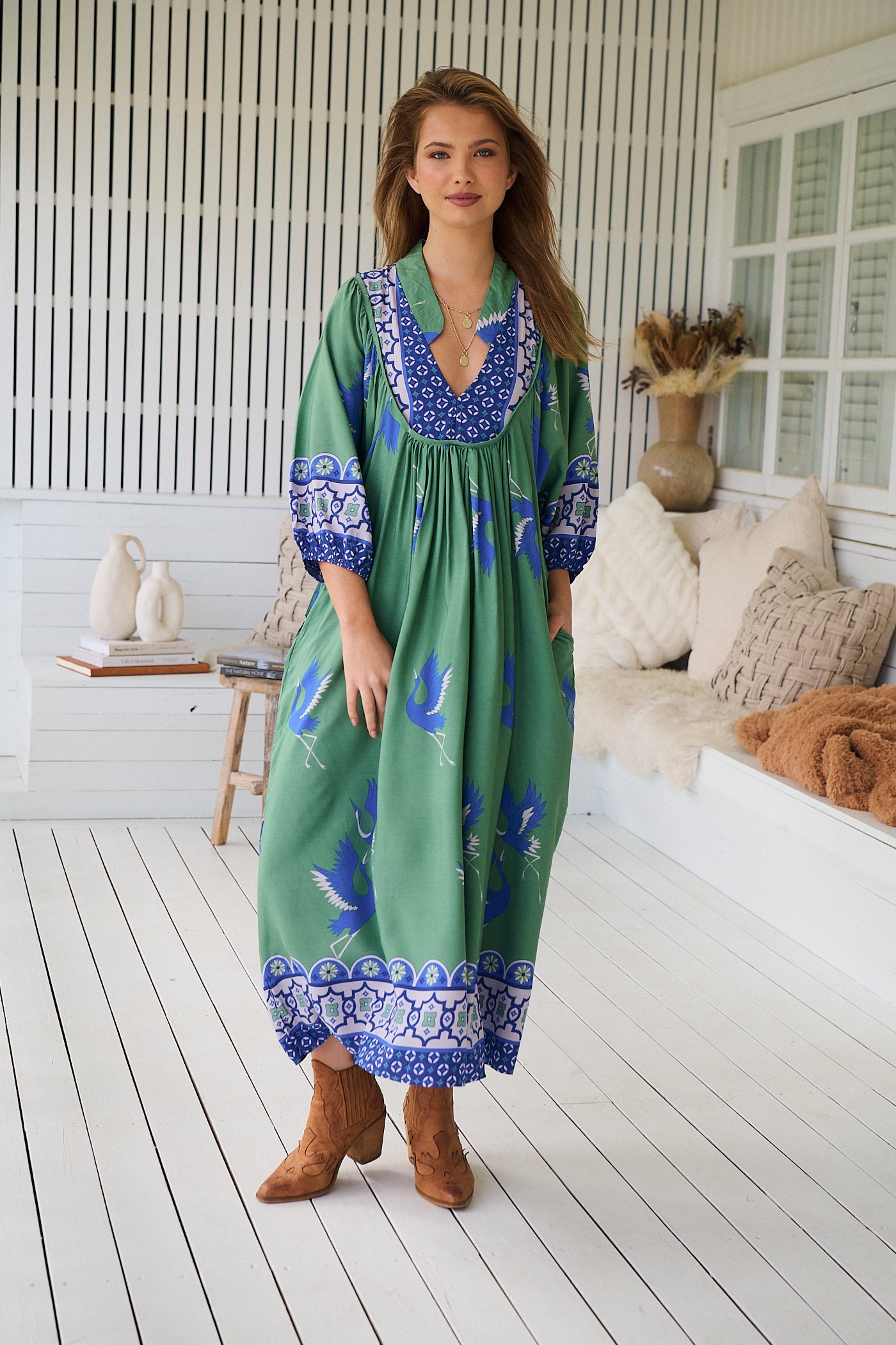 Model wearing Bluebird Boheme Midi Dress by Jaase - boho floral print, long sleeves, soft rayon fabric, relaxed flowy silhouette.