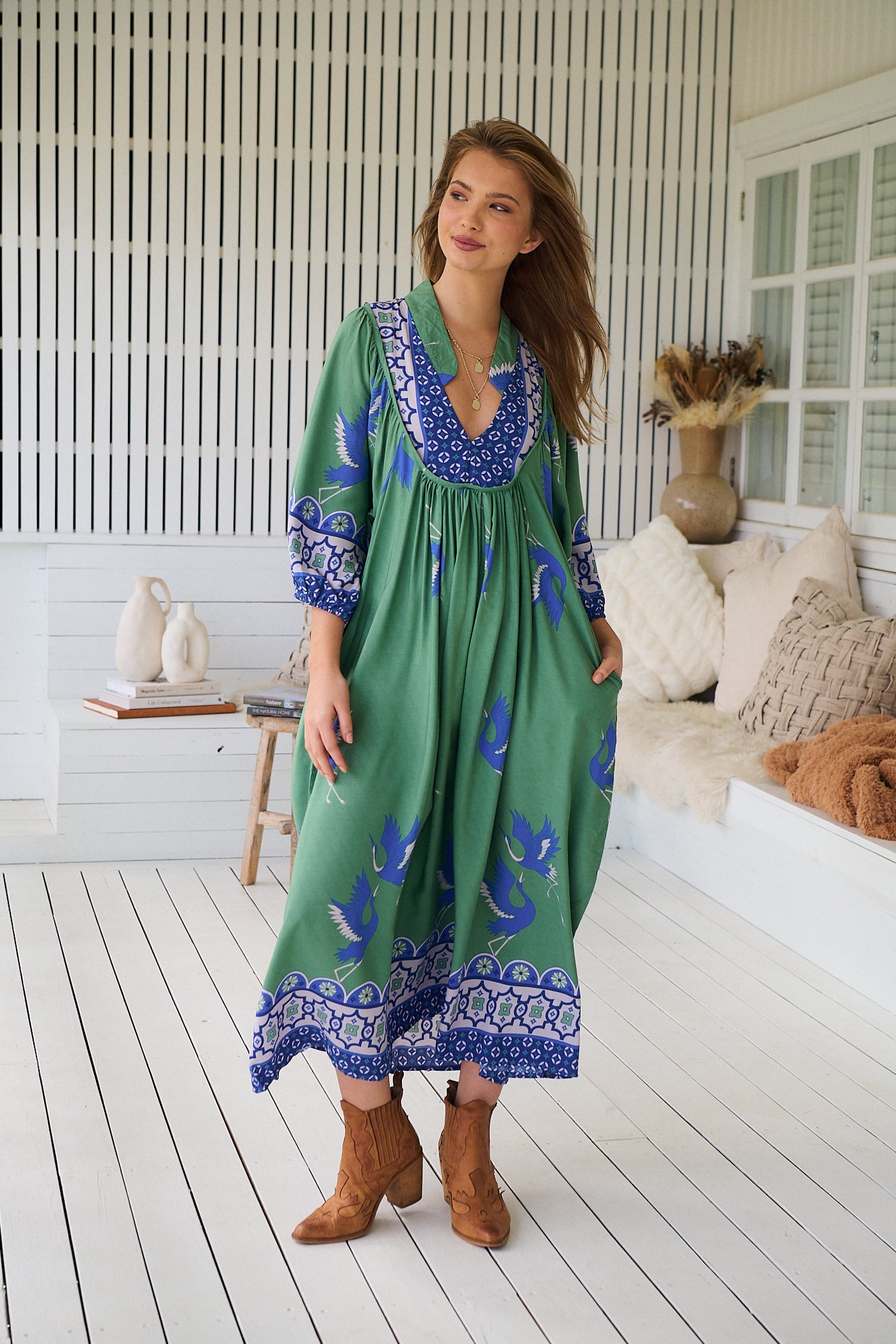 Model wearing Bluebird Boheme Midi Dress by Jaase - boho floral print, long sleeves, soft rayon fabric, relaxed flowy silhouette.