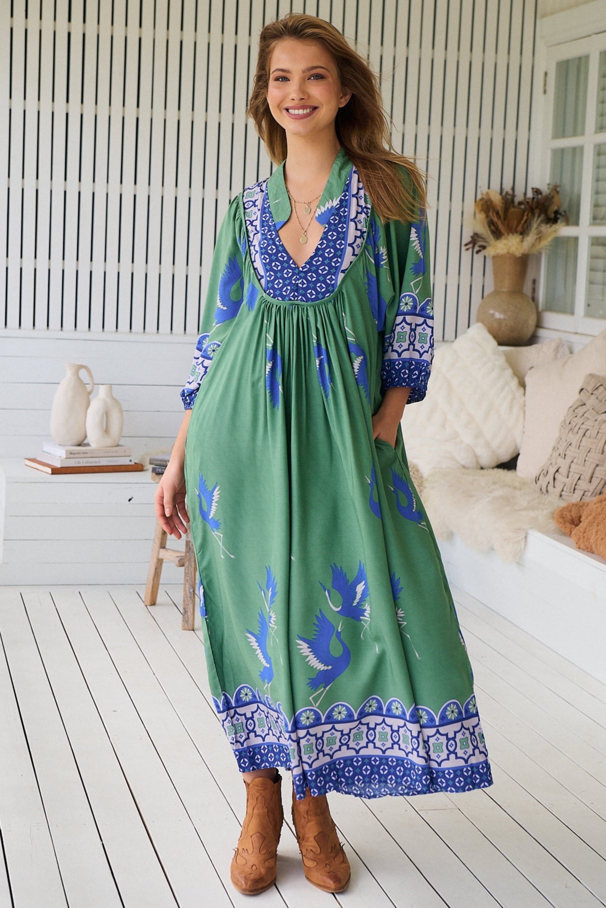 Model wearing Bluebird Boheme Midi Dress by Jaase - boho floral print, long sleeves, soft rayon fabric, relaxed flowy silhouette.