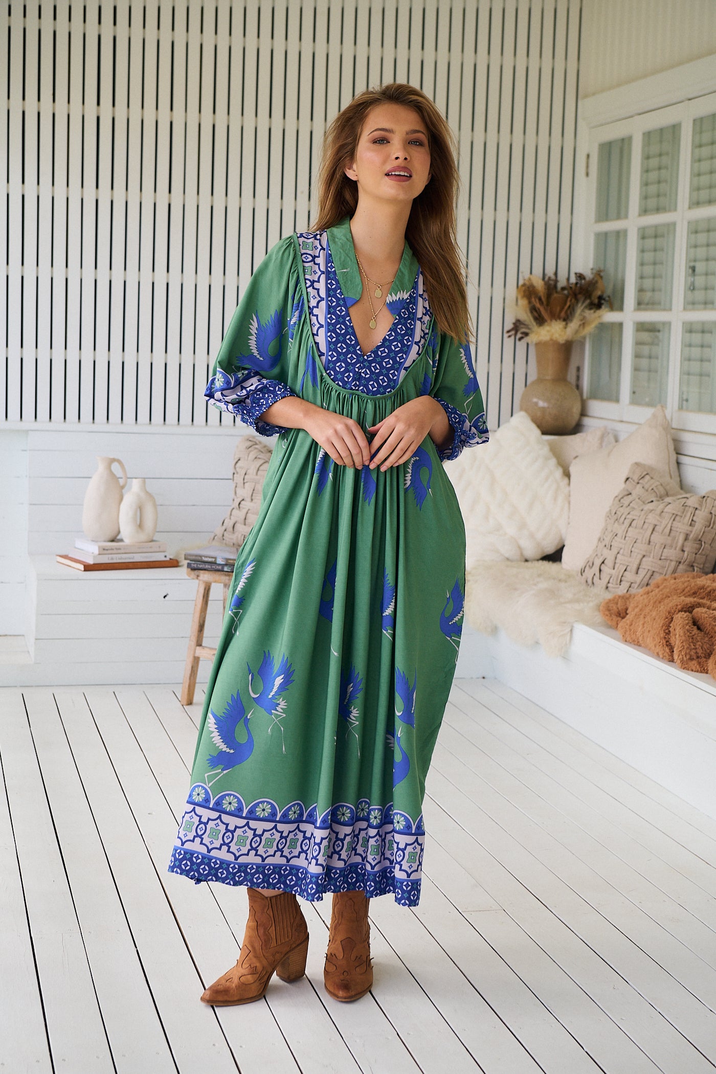 Model wearing Bluebird Boheme Midi Dress by Jaase - boho floral print, long sleeves, soft rayon fabric, relaxed flowy silhouette.