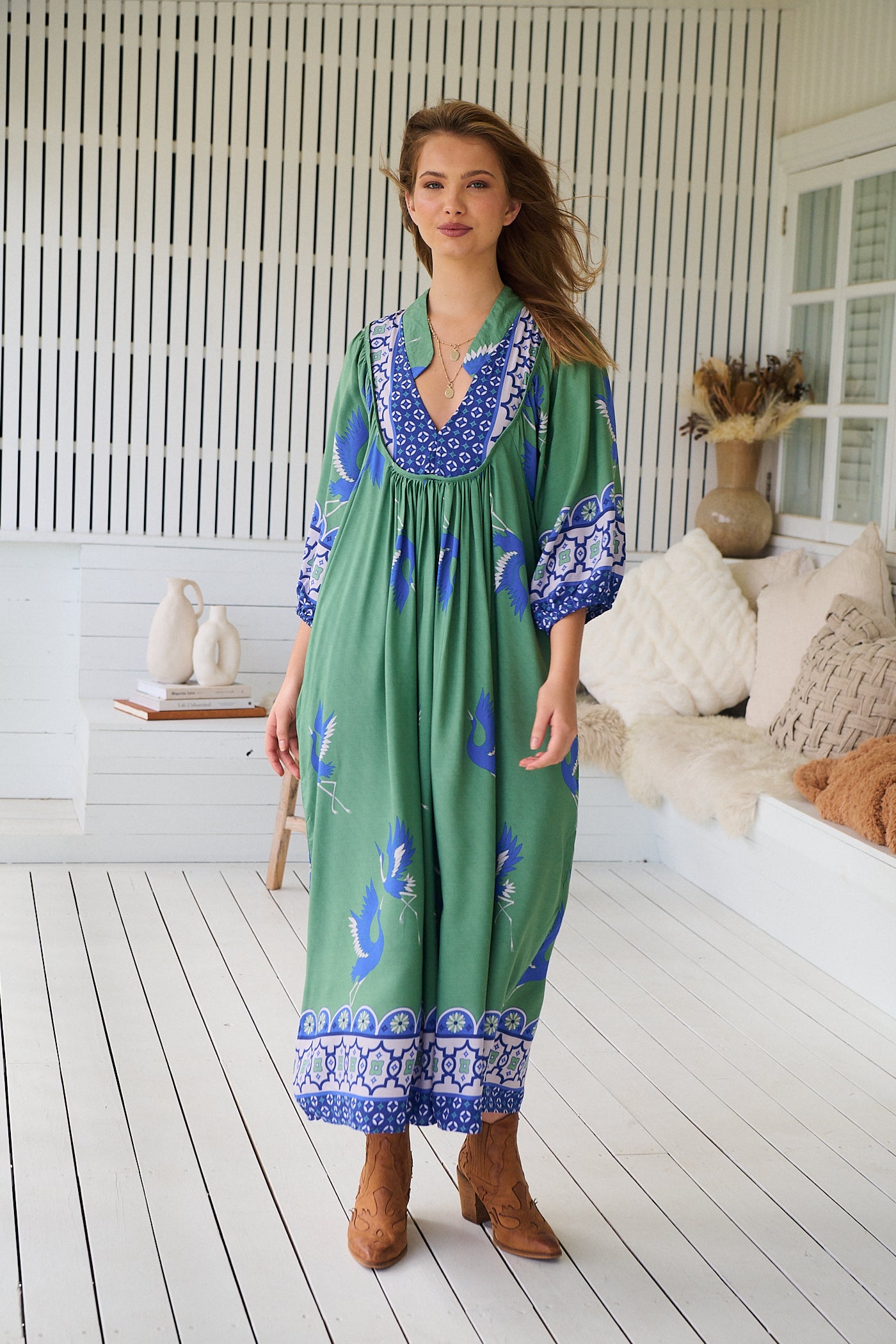 Model wearing Bluebird Boheme Midi Dress by Jaase - boho floral print, long sleeves, soft rayon fabric, relaxed flowy silhouette.