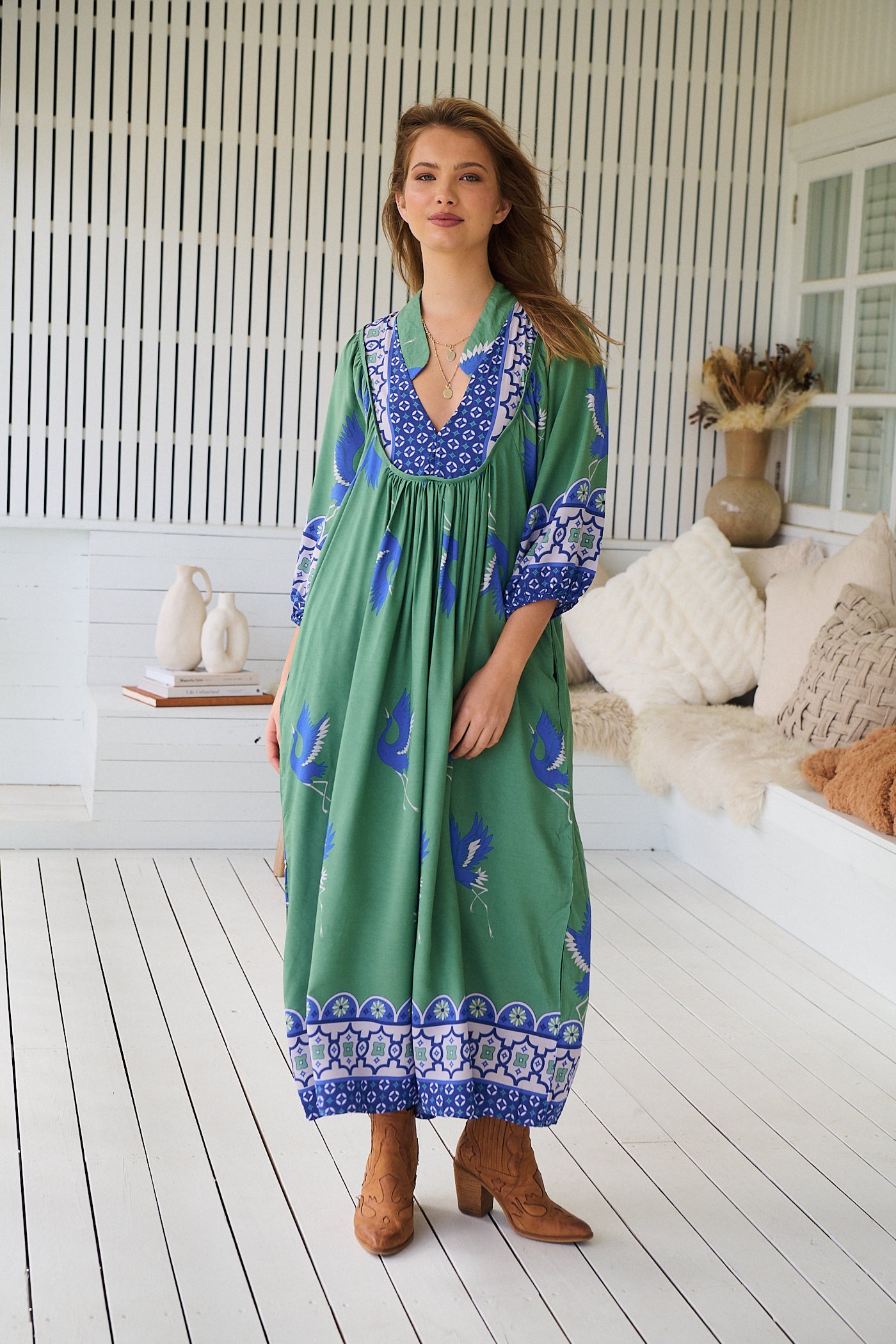 Model wearing Bluebird Boheme Midi Dress by Jaase - boho floral print, long sleeves, soft rayon fabric, relaxed flowy silhouette.