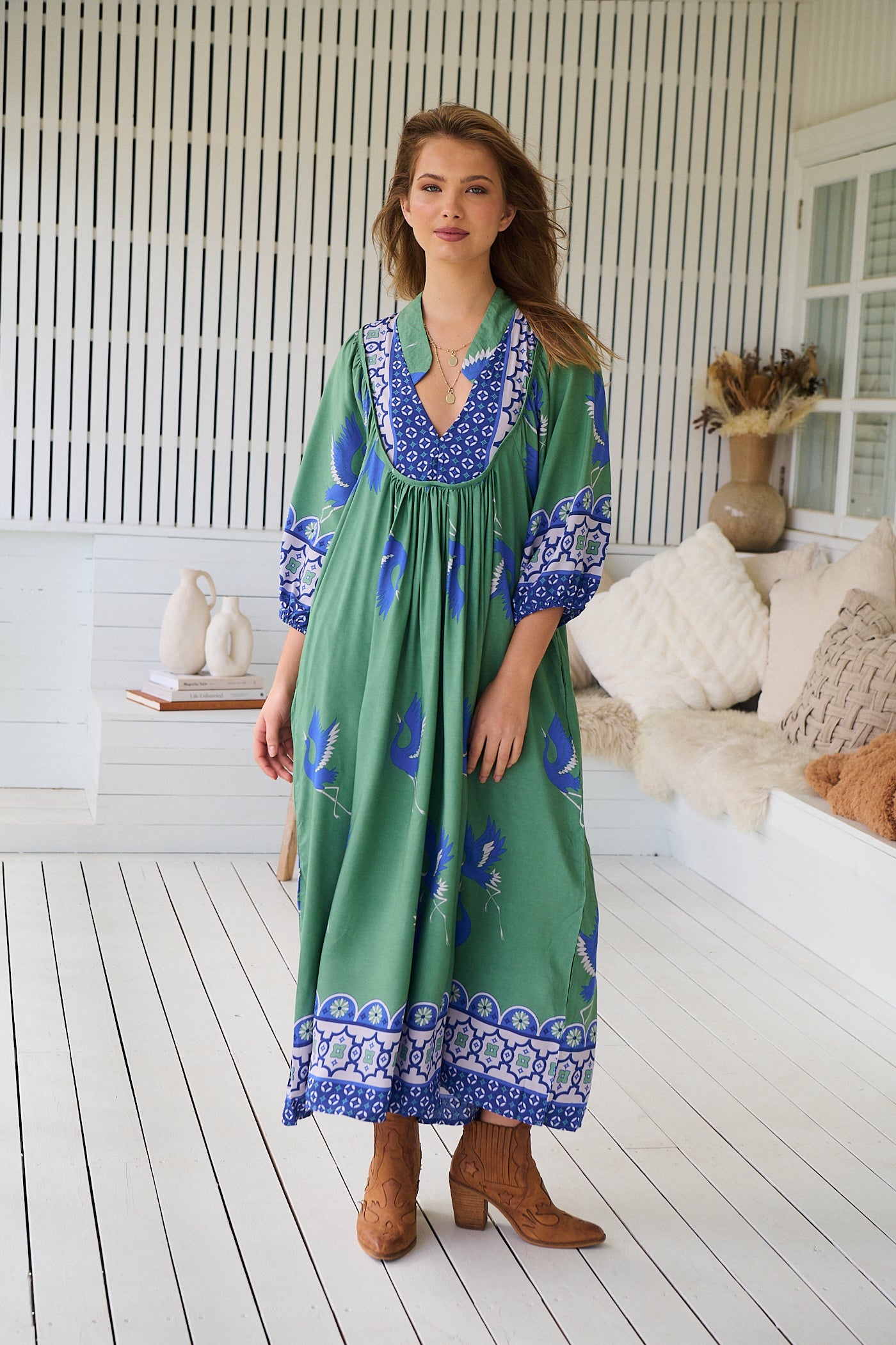 Model wearing Bluebird Boheme Midi Dress by Jaase - boho floral print, long sleeves, soft rayon fabric, relaxed flowy silhouette.
