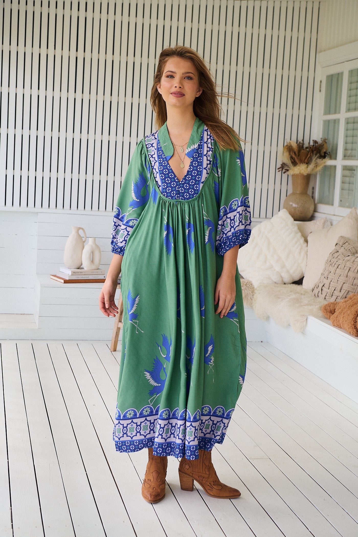 Model wearing Bluebird Boheme Midi Dress by Jaase - boho floral print, long sleeves, soft rayon fabric, relaxed flowy silhouette.