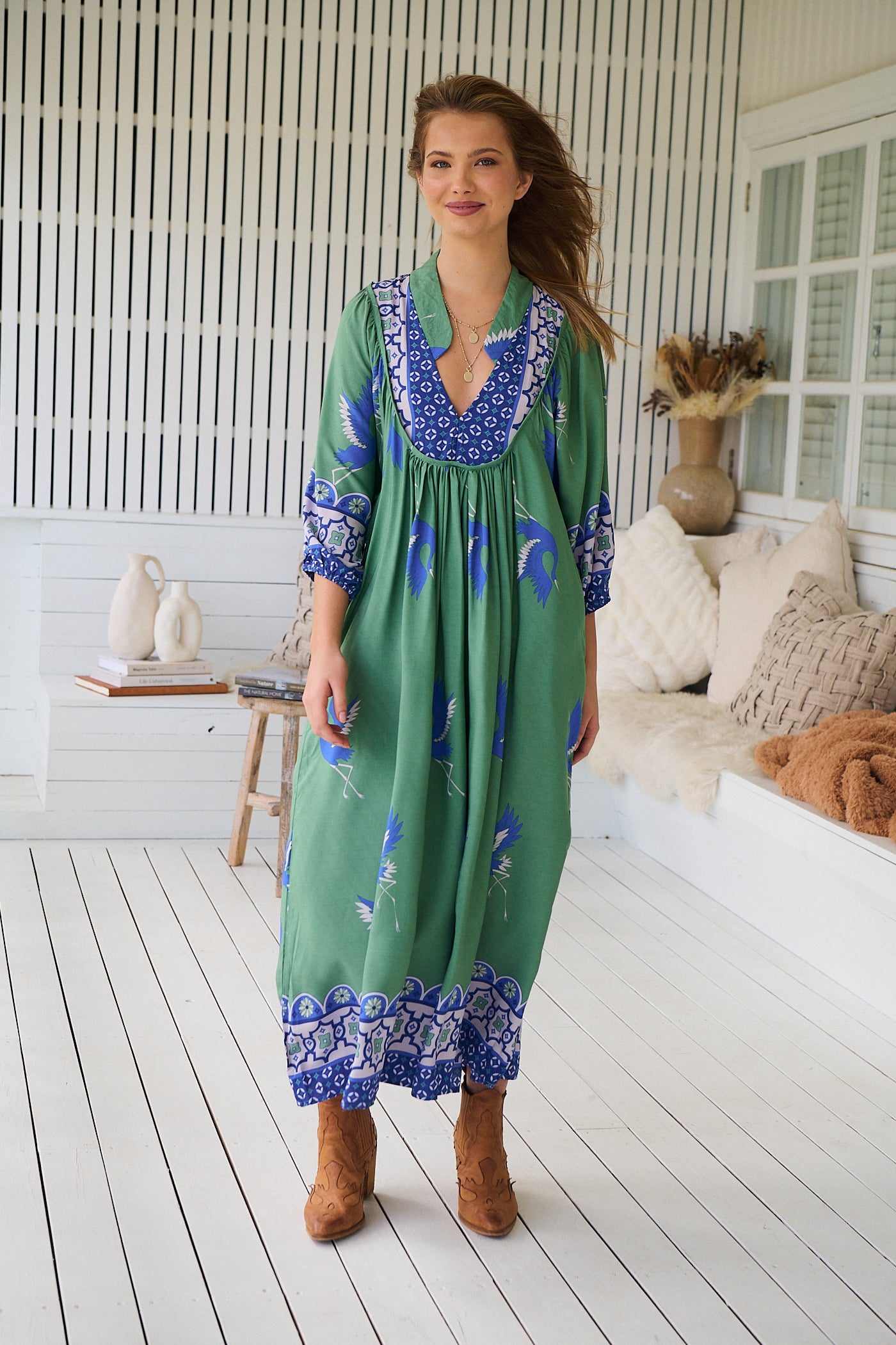Model wearing Bluebird Boheme Midi Dress by Jaase - boho floral print, long sleeves, soft rayon fabric, relaxed flowy silhouette.