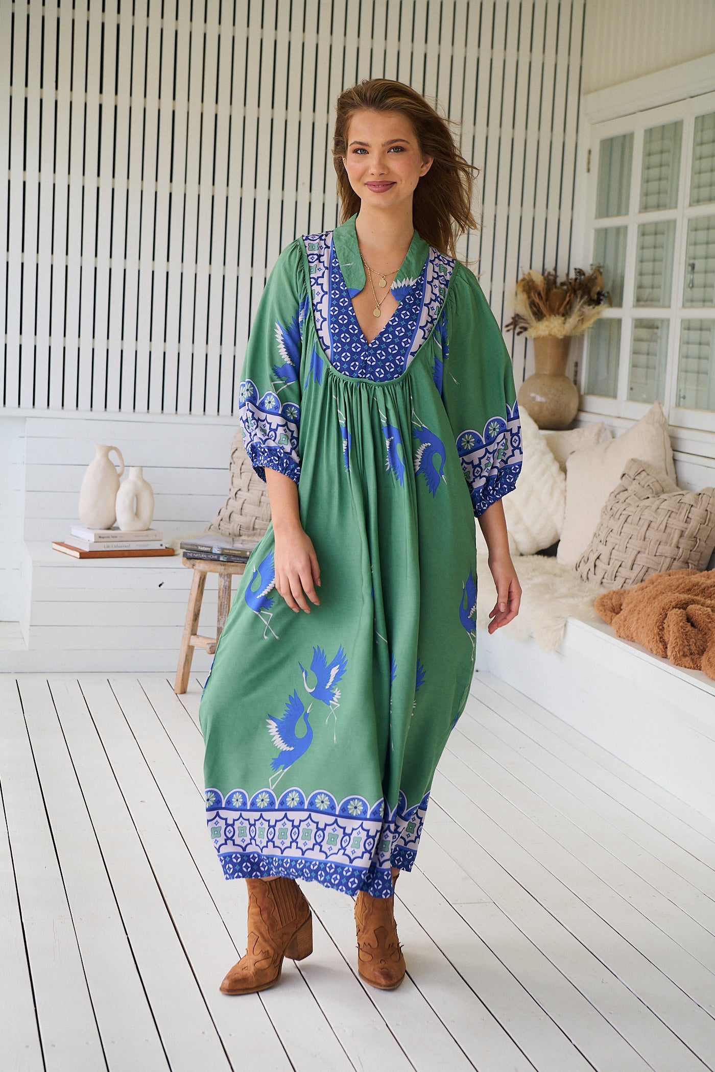 Model wearing Bluebird Boheme Midi Dress by Jaase - boho floral print, long sleeves, soft rayon fabric, relaxed flowy silhouette.