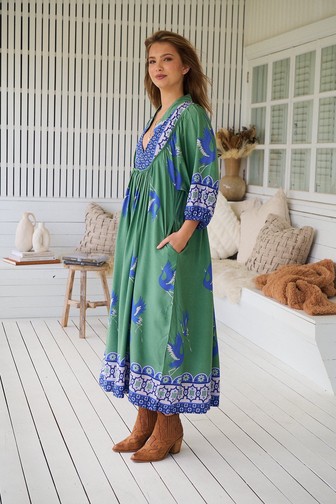 Model wearing Bluebird Boheme Midi Dress by Jaase - boho floral print, long sleeves, soft rayon fabric, relaxed flowy silhouette.