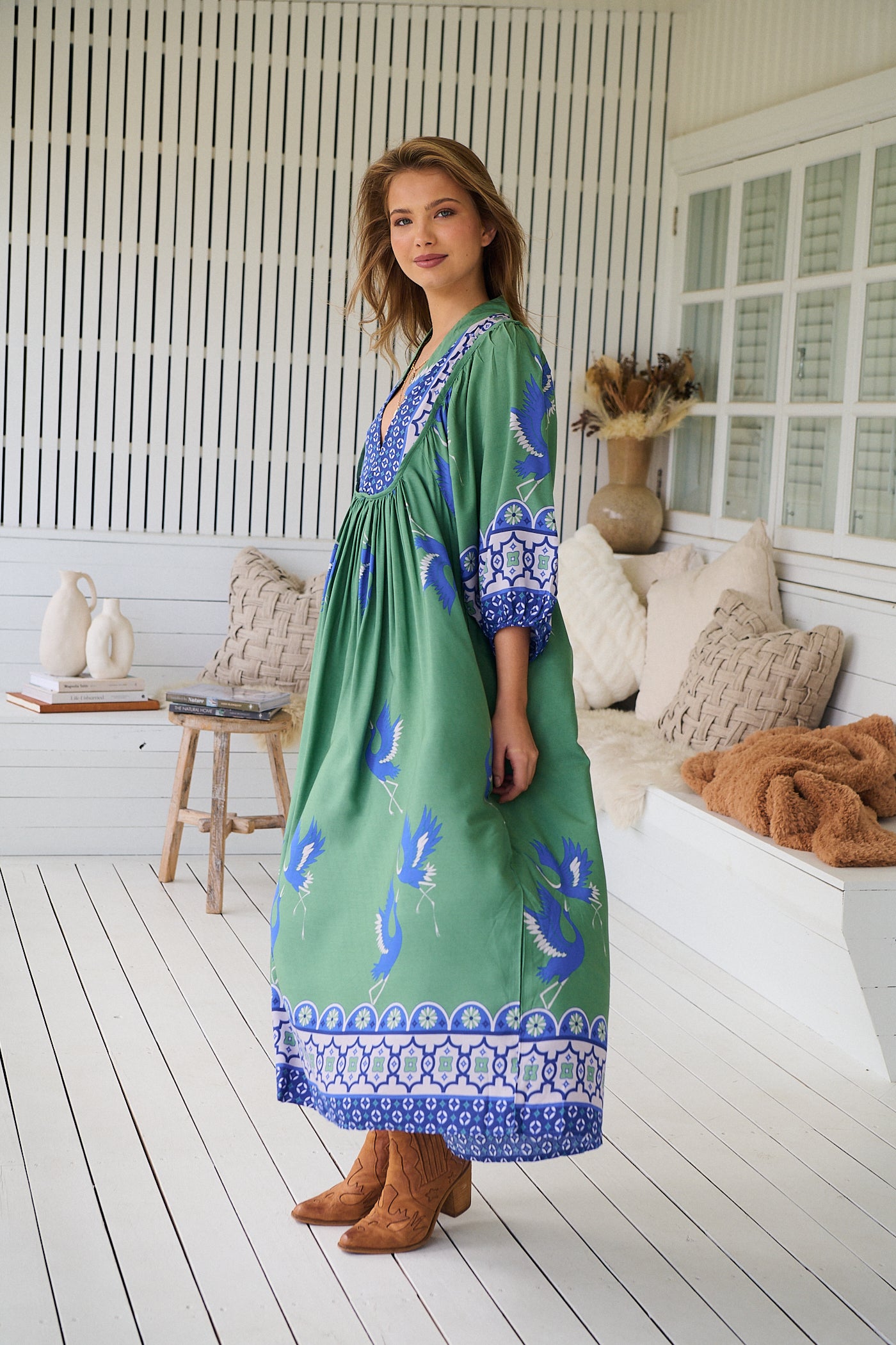 Model wearing Bluebird Boheme Midi Dress by Jaase - boho floral print, long sleeves, soft rayon fabric, relaxed flowy silhouette.