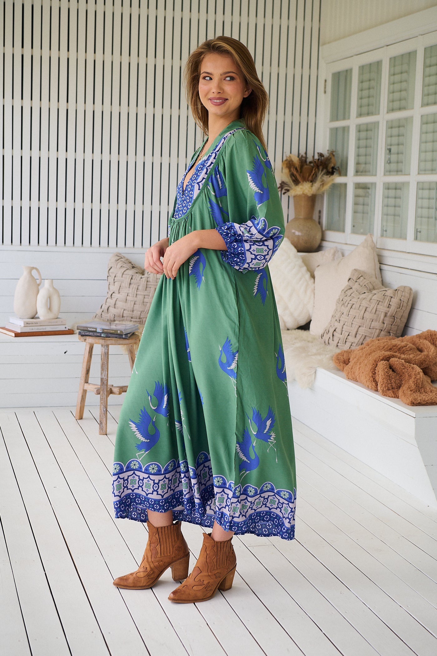 Model wearing Bluebird Boheme Midi Dress by Jaase - boho floral print, long sleeves, soft rayon fabric, relaxed flowy silhouette.