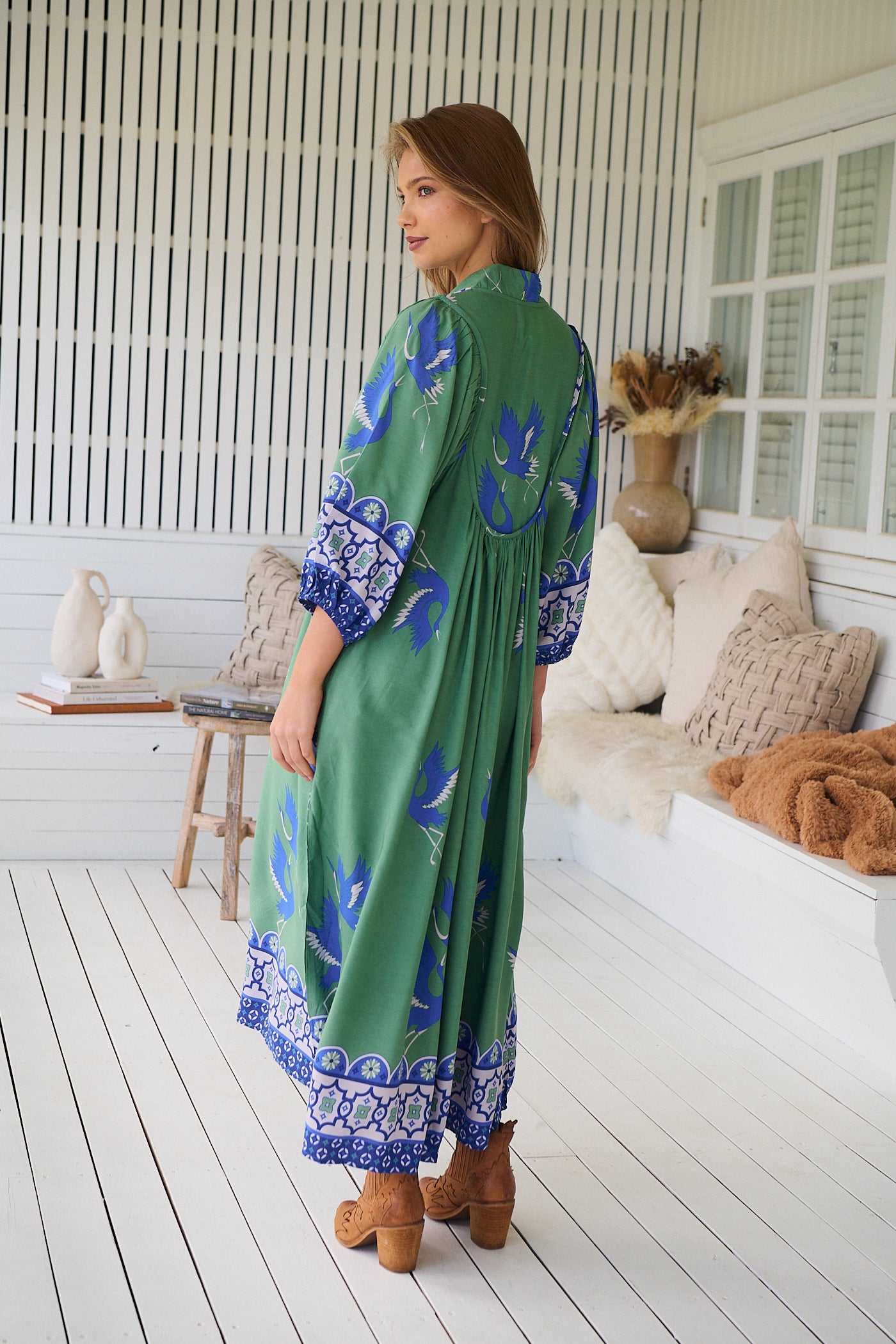 Model wearing Bluebird Boheme Midi Dress by Jaase - boho floral print, long sleeves, soft rayon fabric, relaxed flowy silhouette.