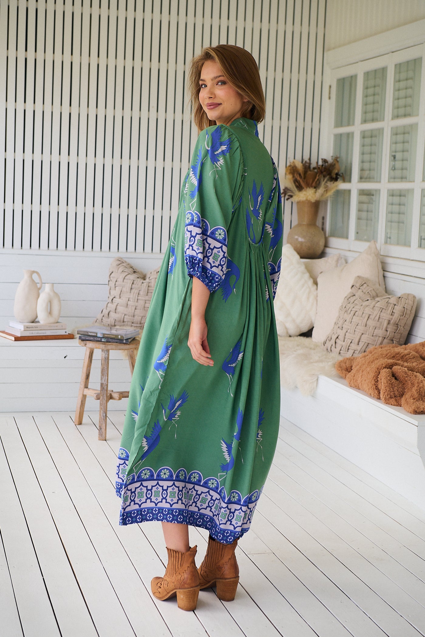 Model wearing Bluebird Boheme Midi Dress by Jaase - boho floral print, long sleeves, soft rayon fabric, relaxed flowy silhouette.